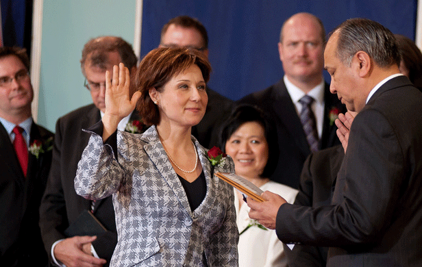 Christy Clark being sworn in as Premier of British Columbia in 2011, surrounded by her cabinet (Province of BC/Flickr)